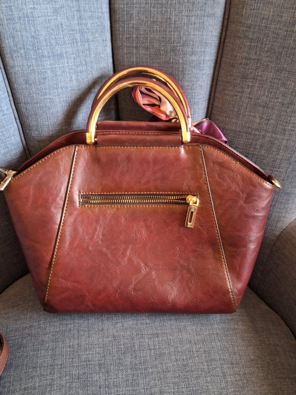Elegant brown handbag with floral design